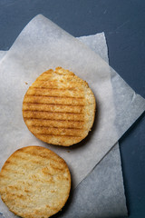 grilled and cut in half burger bun on paper