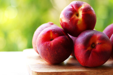peaches in closeup on table, green background