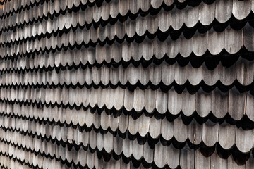 wooden weathered tiles at a house wall of a historic german house,