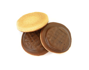 Chocolate coated biscuit cakes with the orange filling isolated over the white background.
