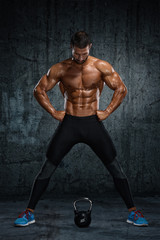 Fototapeta na wymiar Kettlebell Workout. Muscular Men Exercise With Kettlebell
