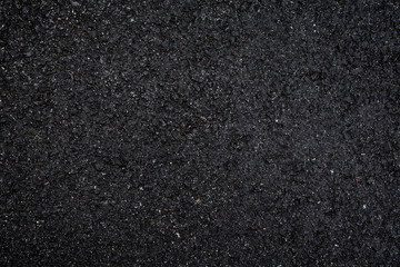 Close-up of wet, black asphalt, viewed from above. High resolution dark full frame textured...