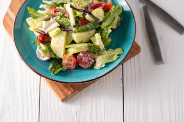 Fresh garden salad on a farmhouse table