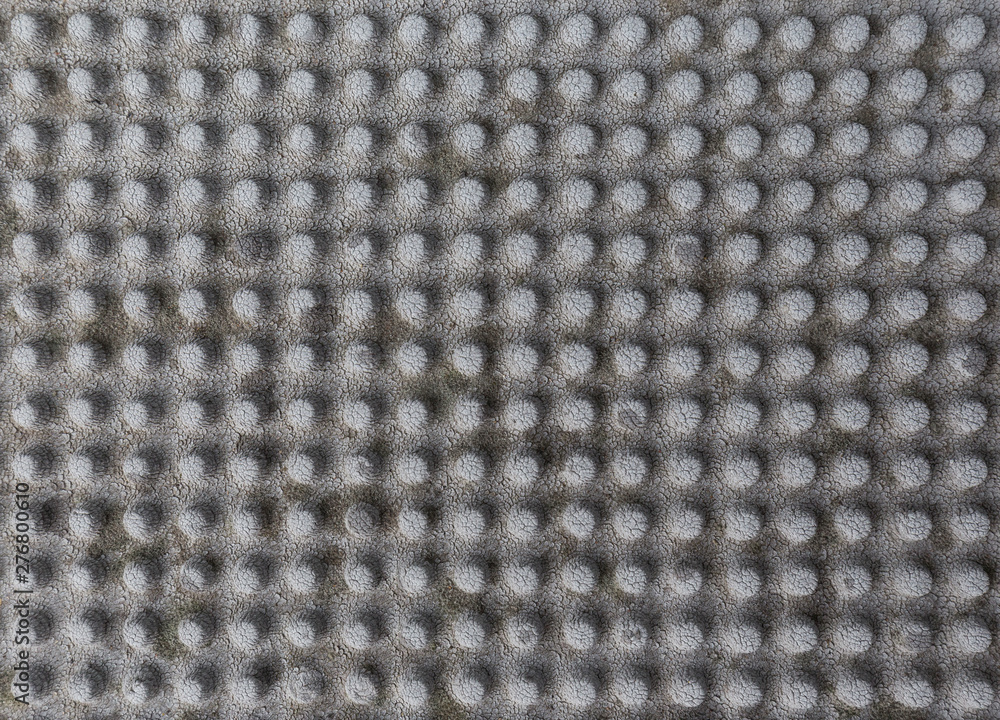 Poster close-up of a weathered and faded rubber mat with knobs. abstract high resolution full frame texture