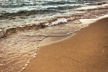 Sandy beach with soft waves