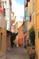 Fototapeta na wymiar narrow colorful pedestrian street in old town of Ville Franche France