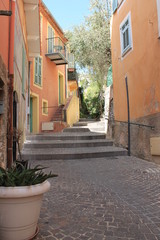 Fototapeta na wymiar Colorful building lined cobblestone steps in old town Villefranche France