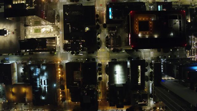 Establishing Aerial View Dow Town Looking at traffic at Night Following car  