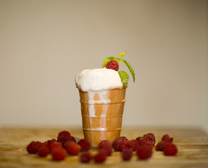 white ice cream with raspberry waffle Cup