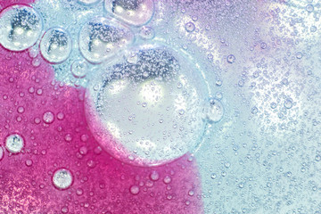 Pink and blue bubbles made of soapy cosmetics, beauty products
