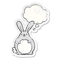 cartoon rabbit and thought bubble as a distressed worn sticker