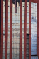 City and sky reflected in the windows of a skyscraper.