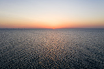 Sea sunrise early morning. Aerial View. Black Sea Sunset. Orange sky and low tide. Sea waves in the...