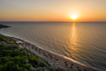 Sea sunrise early morning. Aerial View. Black Sea Sunset. Orange sky and low tide. Sea waves in the rays of a sunset. Sunset on the beach in summer season. Seascape. Sun over the skyline and sea waves