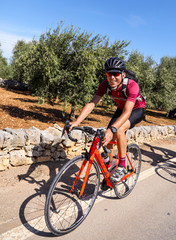 Young athletic man on a road bike cycling. 