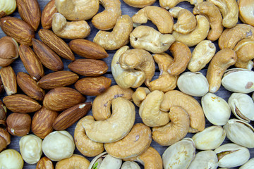 nuts almonds cashew hazelnuts scattered on a wooden table
