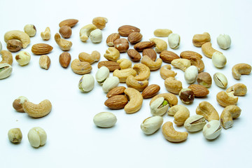 nuts almonds cashew hazelnuts scattered on white background