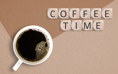cup of coffee on paper background with cubes and text 