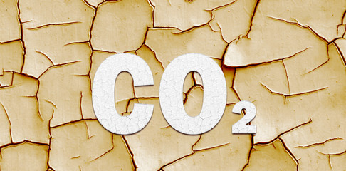 Climate change banner with CO2 lettering over dry cracked mud in a concept of the effect of Global Warming on the planet