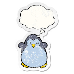 cartoon penguin and thought bubble as a distressed worn sticker