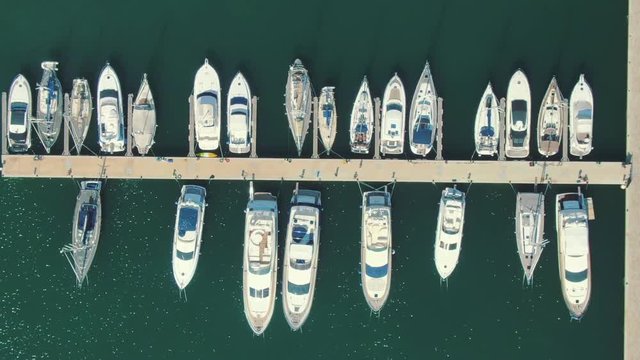 Motorboats and sailboats Santa Pola harbor, aerial view from above, zooming-out