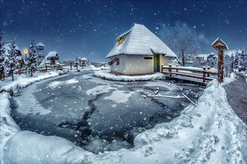 Lake cottage in a winter night