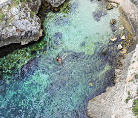 View looking down on a beach in a cove on the coast of southern Italy. 