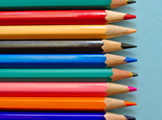 Color pencils isolated on light blue background with copy space.