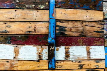Painted wooden boards of various colors aged, natural texture background.