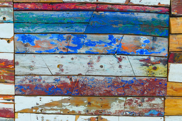 Painted wooden boards of various colors aged, natural texture background.