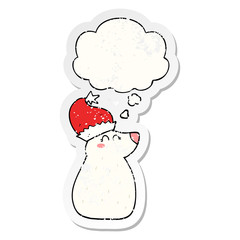cartoon bear wearing christmas hat and thought bubble as a distressed worn sticker
