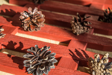 Forest fir cones on the decorative fence on the table