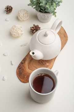 Ceramic white teapot with accessories on a white table, horizontal frame, tea time, tea drinking, retual tea making