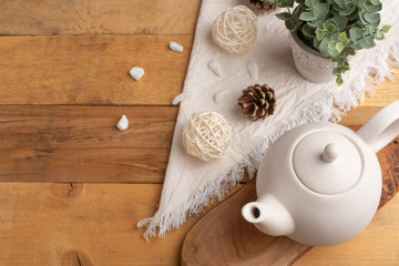 Ceramic white teapot with accessories on a wooden table, horizontal frame, tea time, tea drinking, retual tea making