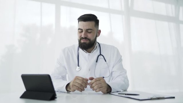 Doctor using tablet pc in office to video chat. 4K