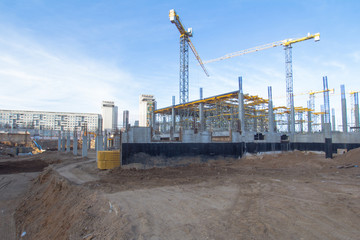 Fototapeta na wymiar Construction area with yellow cranes at summer time. 