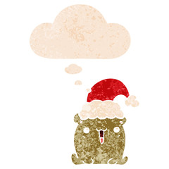 cute cartoon bear with christmas hat and thought bubble in retro textured style