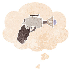 cartoon ray gun and thought bubble in retro textured style