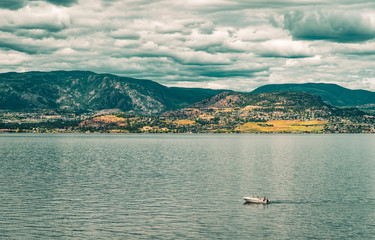 Boat crossing a lake in the mountains