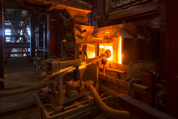 Fototapeta na wymiar large melting furnace.Glass recycling. Bottle manufacturing industrial factory. Molten