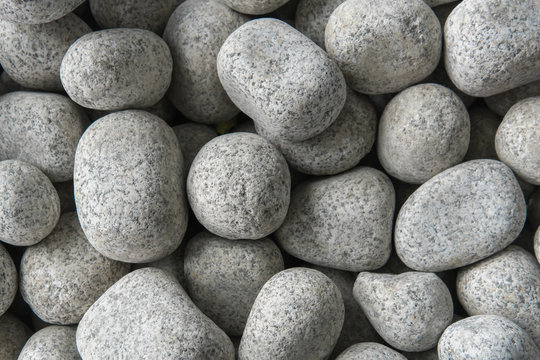 Rough, edged and white pebbles rock on the floor. Close up background image.
