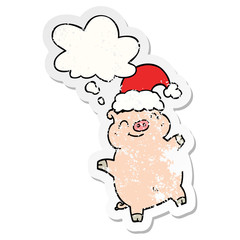 cartoon happy christmas pig and thought bubble as a distressed worn sticker