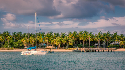 Sailboat anchors off Peanut Island in the tranquil waters of the Palm Beach inlet in south Florida