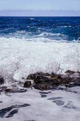 Beautiful view of the coastline of Gran Canaria, rocky shore, atlantic waves, turquise water. 