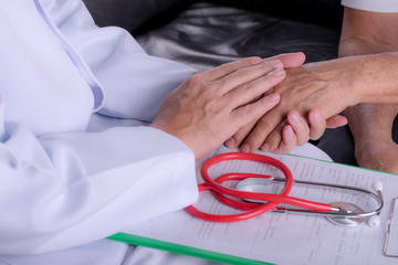 Doctor physician holding hand with the old man to give assistance. Parkinson and alzheimer male senior elderly patient. Health care and medical concept.