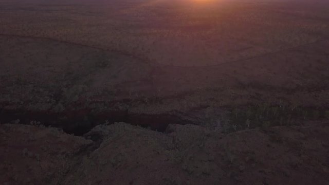 Drone flies over the barren rugged landscape of the Australian Karijini National Park.