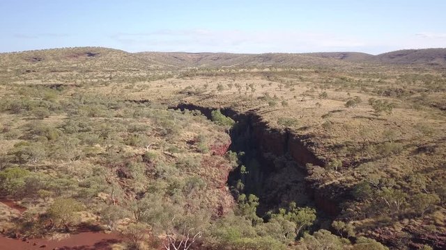 Drone flies over the barren rugged landscape of the Australian Karijini National Park.