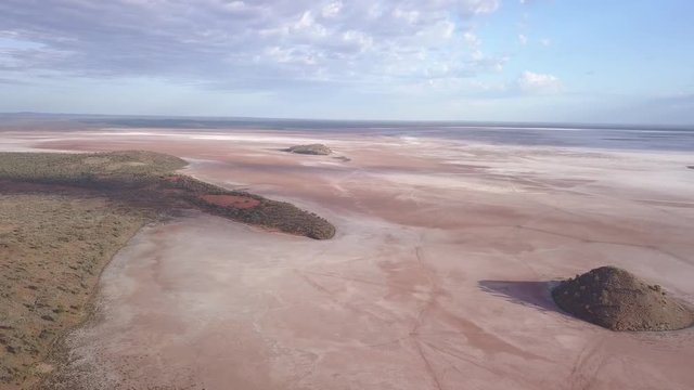 Aerial view of the lake ballard. The lonely hill in front of the lake rises from the flat sand landscape on which the Menzies Gormley statue stand