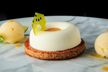 closeup white mini mousse cake with ice cream and limes