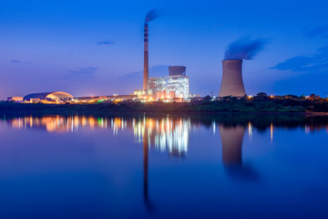 Nuclear power plant after sunset. Dusk landscape with big chimneys.